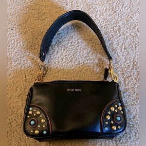 Studded gold and turquoise western vibes pouchette bag in black.